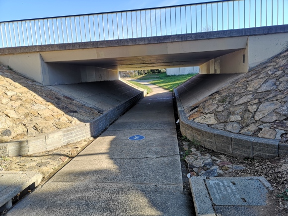 This is not a pedestrian path but a community path and can be used by all active travellers. The blue sign is a warning that school children are likely to walk here. Evatt, Belconnen.