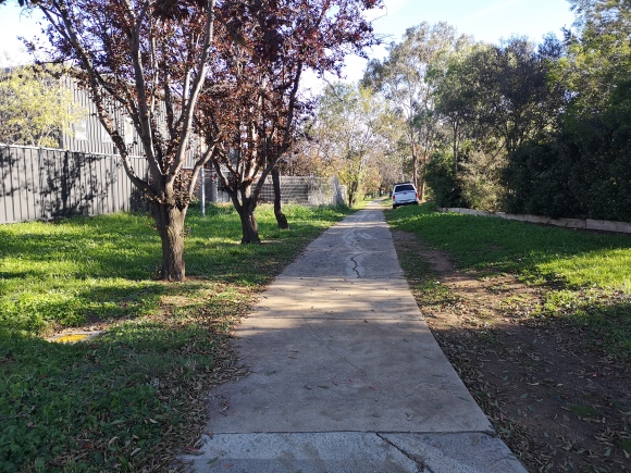 The path is safe but old. At some point, this path will need replacing. Community paths around Evatt local shops, Belconnen