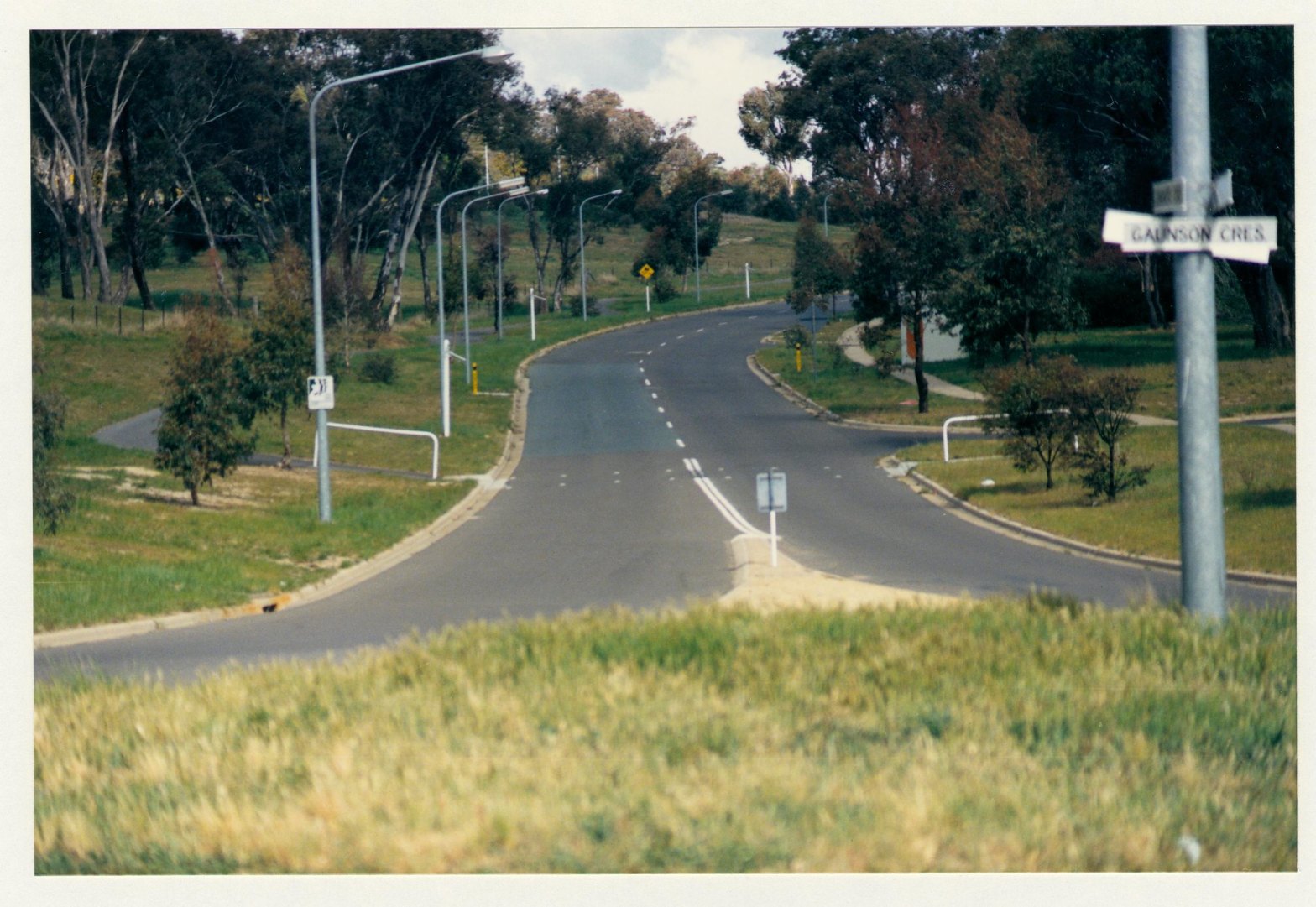 Pathway crossing Longmore Crescent at Gaunson Crescent. View from roadway centre. c1989